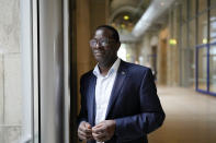 Social Democratic Party, SPD lawmaker Karamba Diaby, poses for a photo at the German parliament Bundestag building, the Reichstag Building, in Berlin, Tuesday, Sept. 28, 2021. Sunday's national election making Germany's lower house of parliament, or Bundestag, more diverse and inclusive than ever before. For the first time there are also two transgender women, at least three people of African descent and, after years of stagnation, the number of female lawmakers has gone up again as well. (AP Photo/Markus Schreiber)