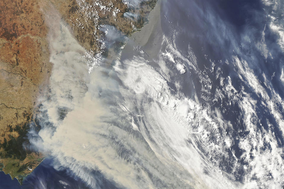 This Jan 1, 2020, photo captured by NASA's Aqua satellite and made available by the Moderate Resolution Imaging Spectroradiometer (MODIS) on NASA's Aqua satellite, shows thick smoke blanketing southeastern Australia along the border of Victoria and New South Wales. More than 200 fires are burning in Australia's two most-populous states. Blazes have also been burning in Western Australia, South Australia and Tasmania. (NASA via AP)