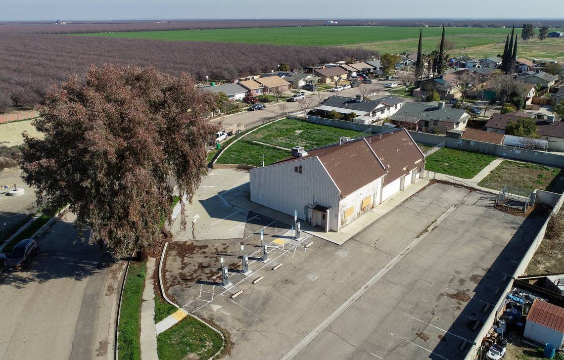 An old fire station is the site of an abandoned electric vehicle charging station in the center of the small farming community of Cantua Creek, as seen from a drone camera on Wednesday, Feb. 8, 2023. 