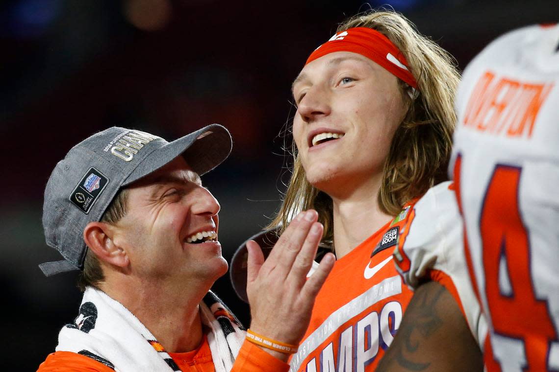 Dabo Swinney (left) announced after Clemson’s win over Boston College that Trevor Lawrence will be out against Notre Dame.
