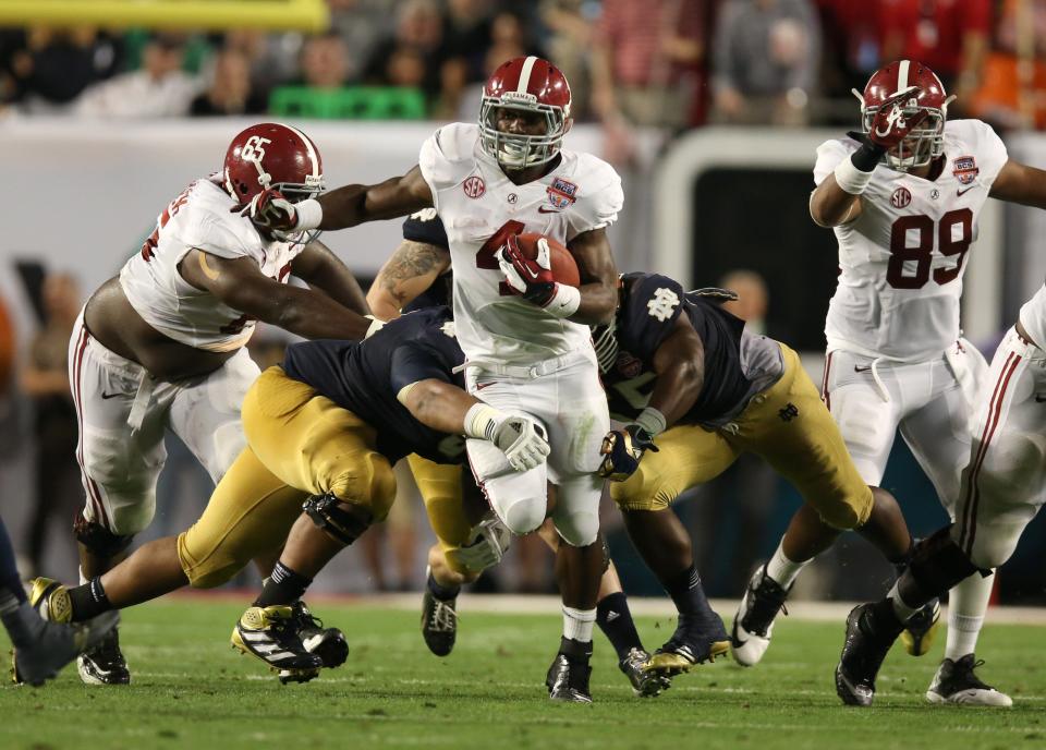 Alabama running back T.J .Yeldon (4) runs with the ball against Notre Dame during the BCS Championship game at Sun Life Stadium, Monday, Jan. 7, 2013.