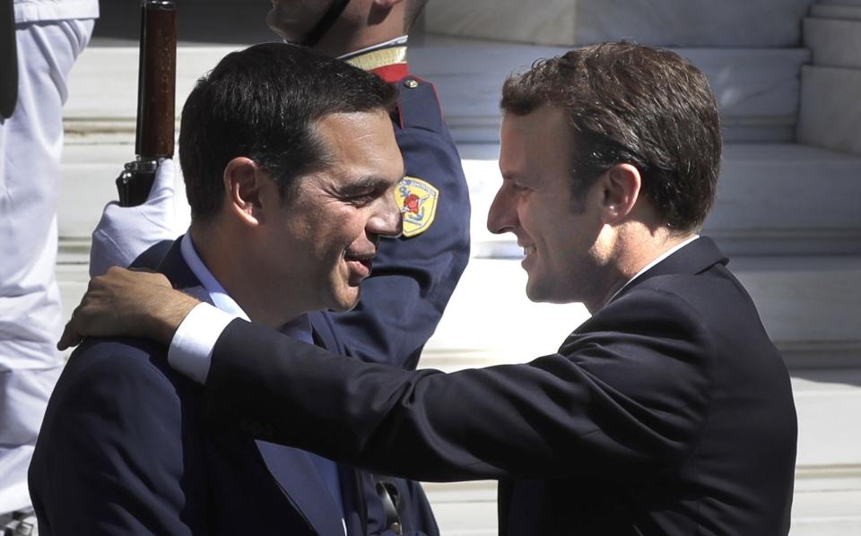 FILE - Greek Prime Minister Alexis Tsipras, left, welcomes French President Emmanuel Macron at Maximos Mansion in Athens, Greece, Sept. 7, 2017. Greece's left-wing opposition leader, Alexis Tsipras has announced his decision to step down after a crushing election defeat. Tsipras made the announcement on Thursday, June 29, 2023. The 48 year-old politician served as Greece's prime minister from 2015 to 2019 during politically tumultuous years as the country struggled to remain in the euro zone and end a series of international bailouts. (AP Photo/Thanassis Stavrakis, File)