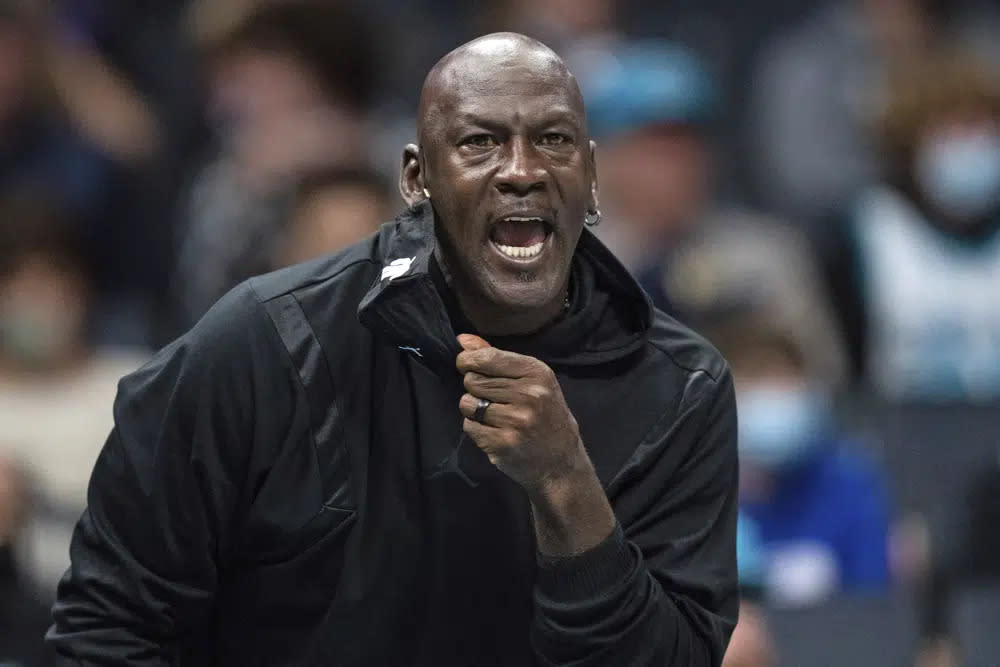 Michael Jordan looks on during the first half of an NBA basketball game between the Charlotte Hornets and the New York Knicks in Charlotte, N.C., Friday, Nov. 12, 2021. (AP Photo/Jacob Kupferman, File)