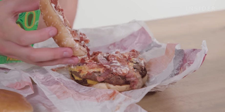 A Bacon King burger with the top bun removed to show the toppings