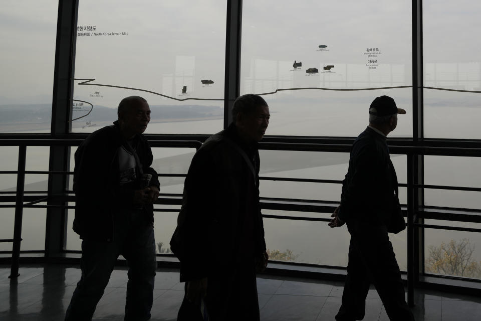 Visitors look at the North Korean side from the unification observatory, in Paju, South Korea, Wednesday, Nov. 22, 2023. South Korea will partially suspend an inter-Korean agreement Wednesday to restart frontline aerial surveillance of North Korea, after the North said it launched a military spy satellite in violation of United Nations bans, Seoul officials said. (AP Photo/Lee Jin-man)