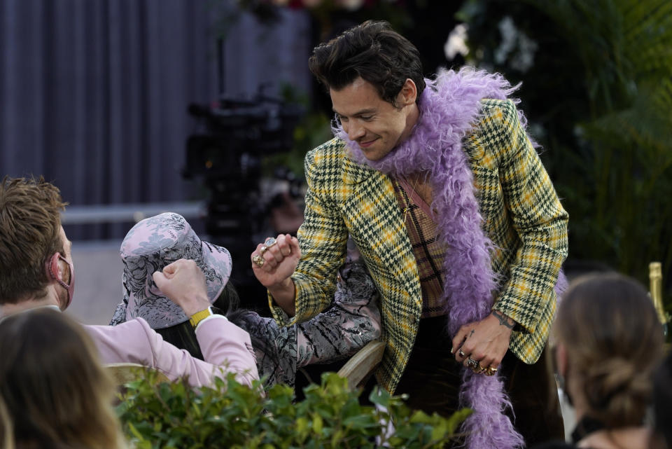 Harry Styles is congratulated by Billie Eilish for winning the award for best pop solo performance for "Watermelon Sugar"at the 63rd annual Grammy Awards at the Los Angeles Convention Center on Sunday, March 14, 2021. (AP Photo/Chris Pizzello)