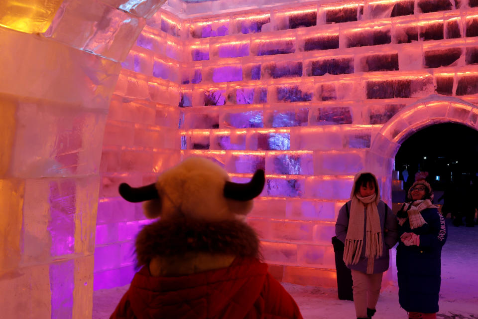 Visitors walk around ice sculptures illuminated by colored lights during the annual ice festival in Harbin, Heilongjiang province, China, on Jan. 4, 2019. (Photo: Tyrone Siu/Reuters)