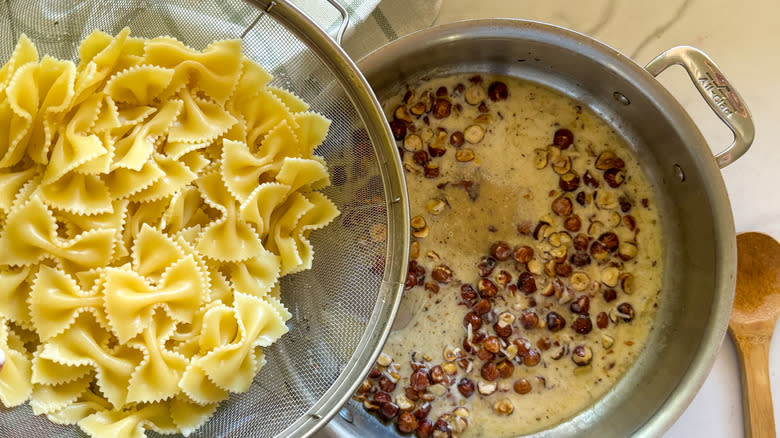 adding pasta to pan