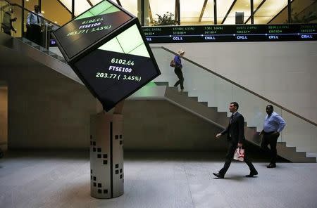 People walk through the lobby of the London Stock Exchange in London, Britain August 25, 2015. REUTERS/Suzanne Plunkett
