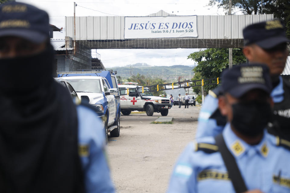 An ambulance is seen at the entrance of the women's prison in Tamara, on the outskirts of Tegucigalpa, Honduras, Tuesday, June 20, 2023. A riot at the women's prison has left at least 41 inmates dead, most of them burned to death, a Honduran police official said. (AP Photo/Elmer Martinez)