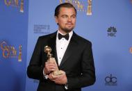 Actor Leonardo DiCaprio poses with the award for Best Actor in a Motion Picture, Musical or Comedy for his role in "The Wolf of Wall Street" at the 71st annual Golden Globe Awards in Beverly Hills, California January 12, 2014. REUTERS/Lucy Nicholson