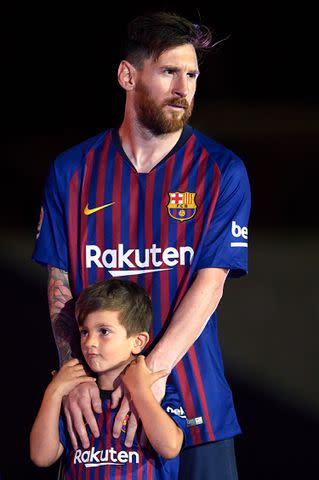 <p>Quality Sport Images/Getty</p> Lionel Messi and son Thiago Messi