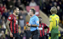 Bournemouth's Steve Cook, left, is sent-off by match referee Paul Tierney during the English Premier League soccer match between Norwich City and Bournemouth at the Carrow Road Stadium, Norwich, England. Saturday, Jan. 18, 2020.(Joe Giddens/PA via AP)
