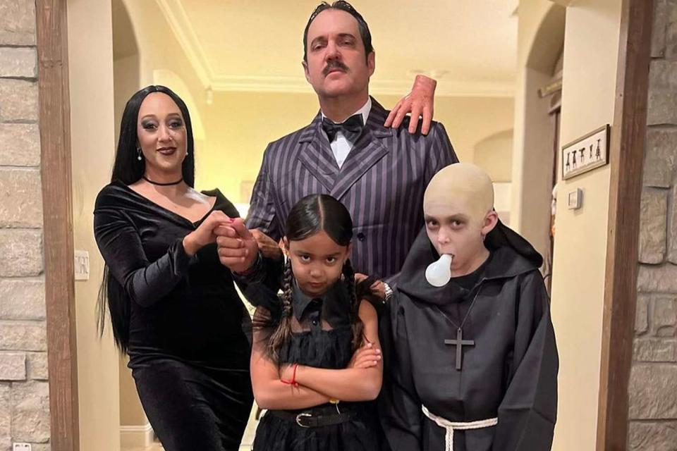 <p>Tamera Mowry/Instagram</p> Tamera Mowry and her family dress as the Addams Family for Halloween.