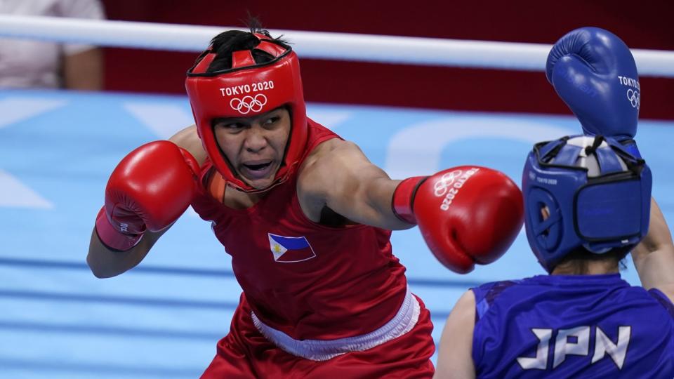 Nesthy Petecio exchanges punches with Japan's Sena Irie during their women's featherweight division title match.