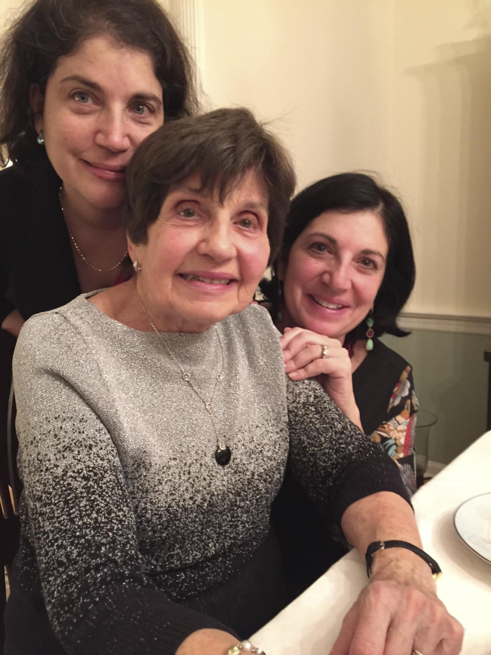 In this photo provided by the D'Innocenzio Family Collection, writer Anne D'Innocenzio, from left, her mother Marie D'Innocenzio and her sister Donna Burke pose for a photo at the family's childhood home, on Dec. 25, 2014, in suburban New Jersey. D'Innocenzio and Burke sold their childhood home after their mother passed away in February 2023, saying goodbye to more than a half century of memories. (D'Innocenzio Family Collection via AP)