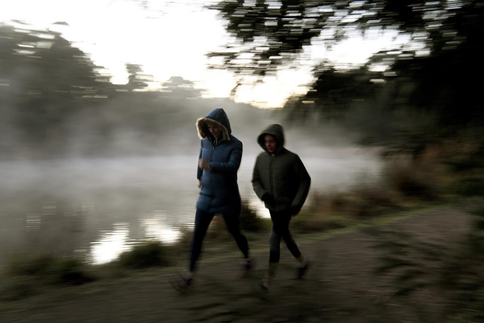 Walkers at Birdsland reserve in Belgrave South, which is east of Melbourne, are seen in jackets and hoods braving the winter cold in June 2018.