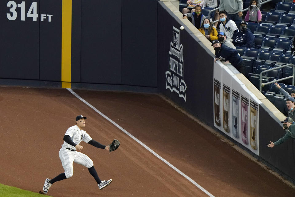 New York Yankees right fielder Aaron Judge fields chases after Baltimore Orioles Trey Mancini's third-inning ground rule double in a baseball game, Tuesday, April 6, 2021, at Yankee Stadium in New York. (AP Photo/Kathy Willens)