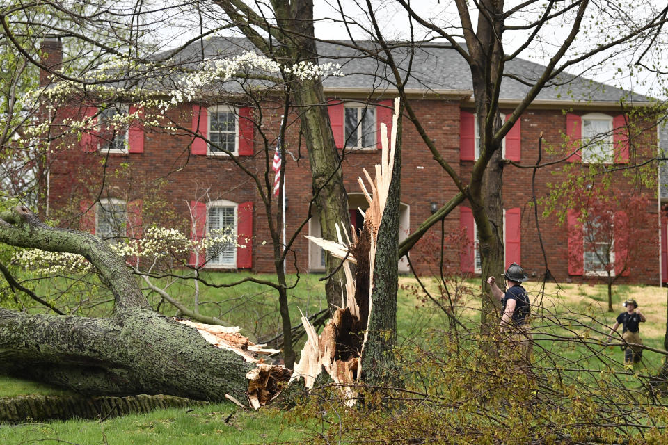 Firefighters with the Anchorage Middletown Fire Department check houses for gas leaks following severe storms that passed through Prospect, Ky., Tuesday, April 2, 2024. (AP Photo/Timothy D. Easley)