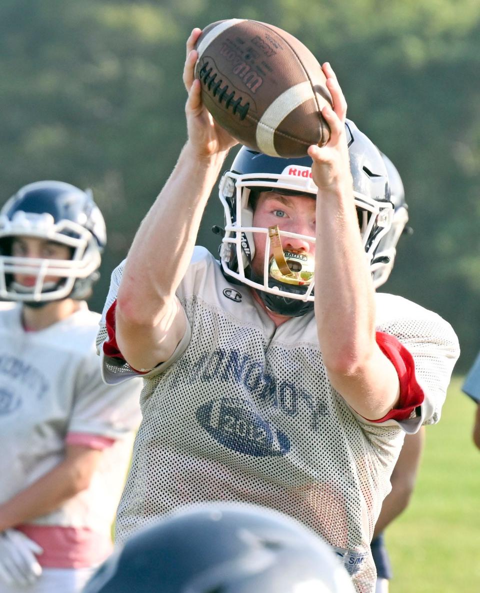 Monomoy quarterback Jake Vagenas takes a snap during football practice.