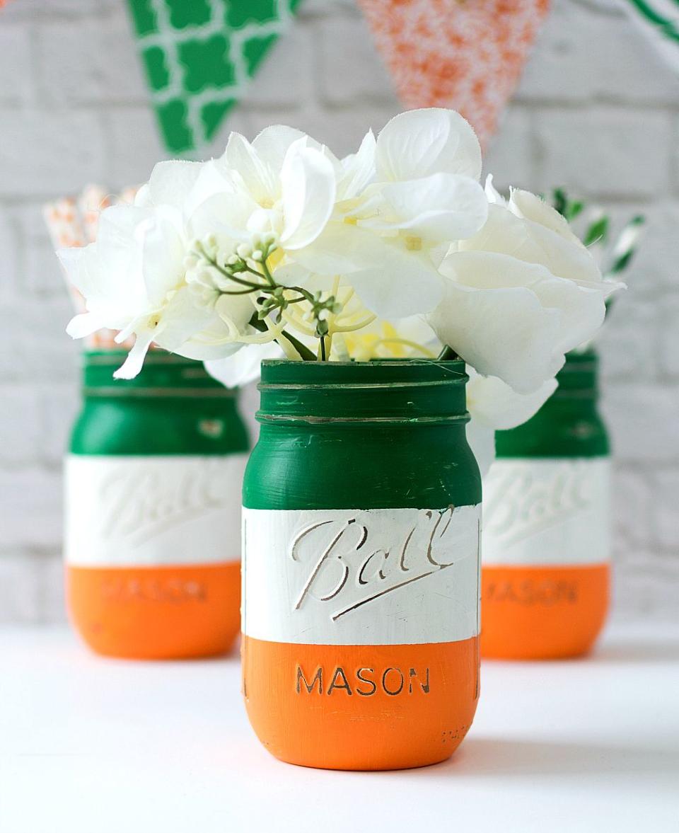 a bottle of oil with white flowers