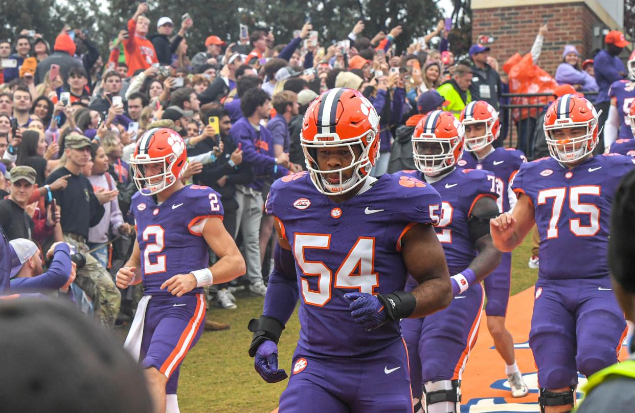 Clemson linebacker Jeremiah Trotter Jr. (54) runs down the hill with the team before playing Georgia Tech on Nov. 11. Trotter will not play in the Gator Bowl, as he is forgoing his senior season to enter the NFL draft.