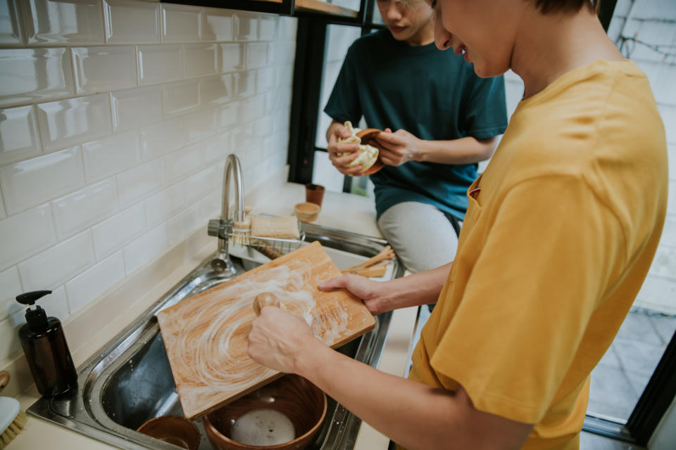 person washing a cutting board