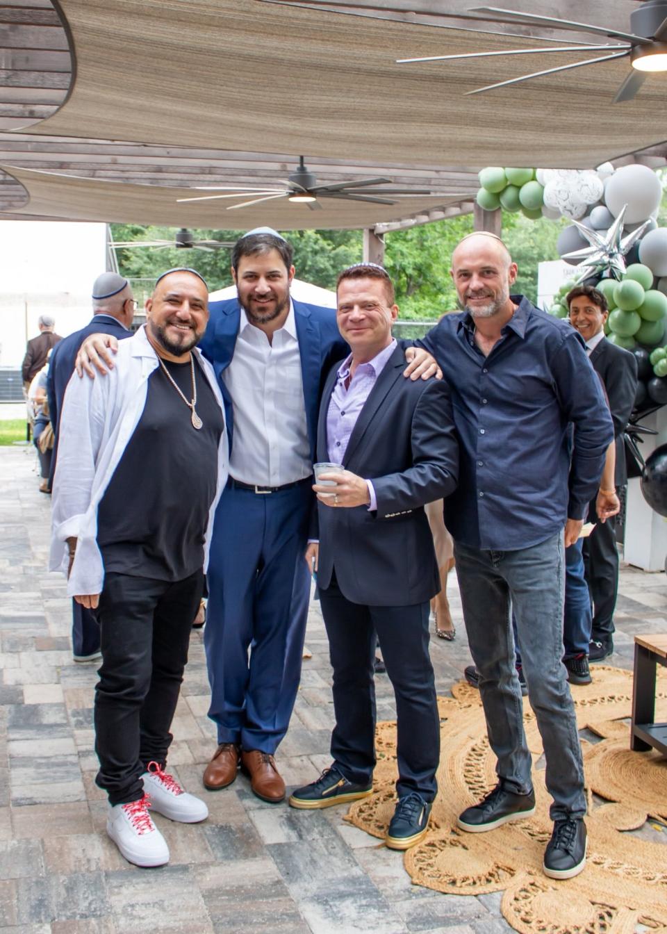 Rabbi Shmuli Novack (second from left) is pictured with David “Papi” Einhorn, Dr. Dmitriy Model and Ryan Shapiro during the June 4 dedication of a new outdoor event space at Chabad of Southside.