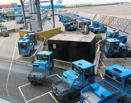 Trucks are seen on the tarmac at Amsterdam Schiphol airport