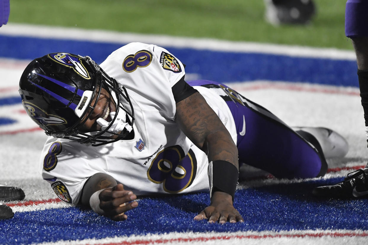 Baltimore Ravens quarterback Lamar Jackson (8) reacts after being injured during the second half of an NFL divisional round football game against the Buffalo Bills Saturday, Jan. 16, 2021, in Orchard Park, N.Y. (AP Photo/Adrian Kraus)