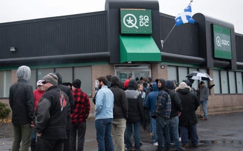 People line up outside of a cannabis store in Quebec City, Quebec - Credit: ALICE CHICHE/AFP/Getty Images