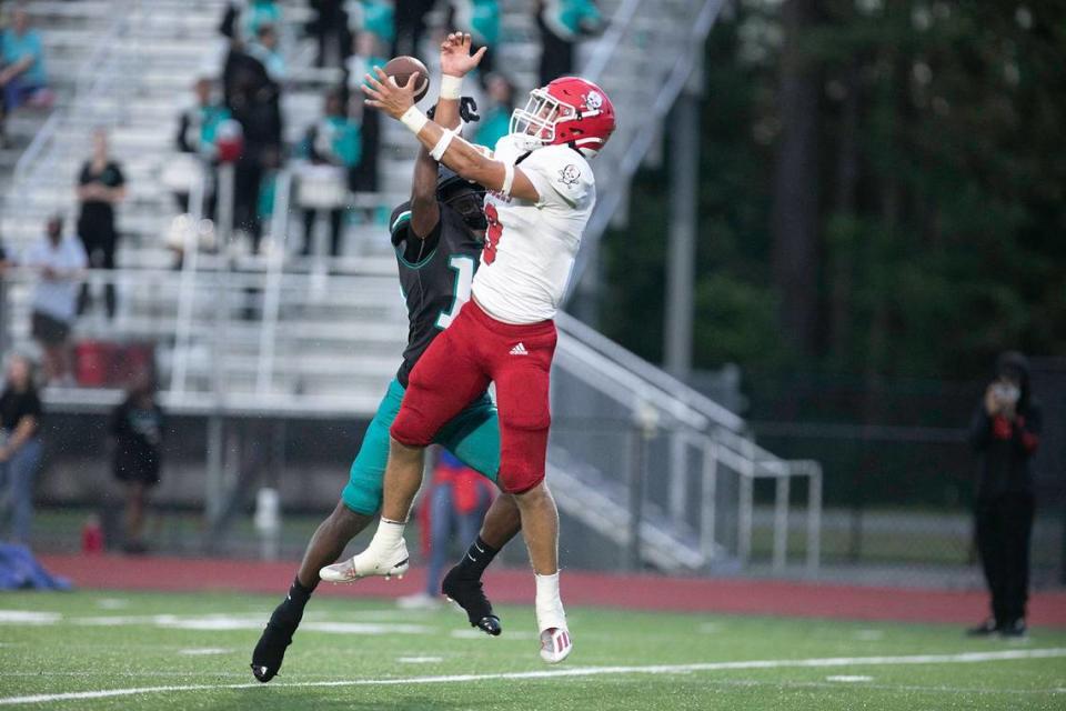 Savannah Christian’s David Bucey leaps over an Island’s defender and comes down with the catch during a game on Aug. 26, 2022. Kyunnie Shuman/USA TODAY NETWORK