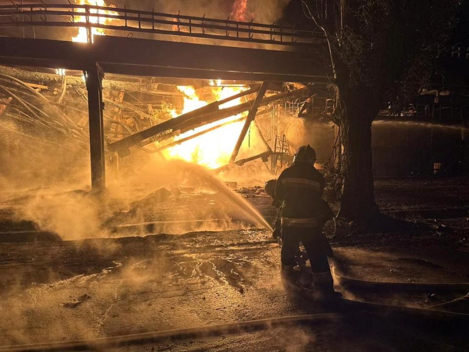 Firefighters work at an oil refinery hit during Russia’s drone attacks in Kremenchuk (via Reuters)