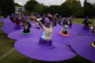Members of the Mahogany carnival group take part in a rehearsal for their upcoming performance at the Platinum Jubilee Pageant, at Queens Park Community School, in north London, Saturday, May 28, 2022. Britain is getting ready for a party featuring mounted troops, solemn prayers — and a pack of dancing mechanical corgis. The nation will celebrate Queen Elizabeth II’s 70 years on the throne this week with four days of pomp and pageantry in central London. (AP Photo/Matt Dunham)
