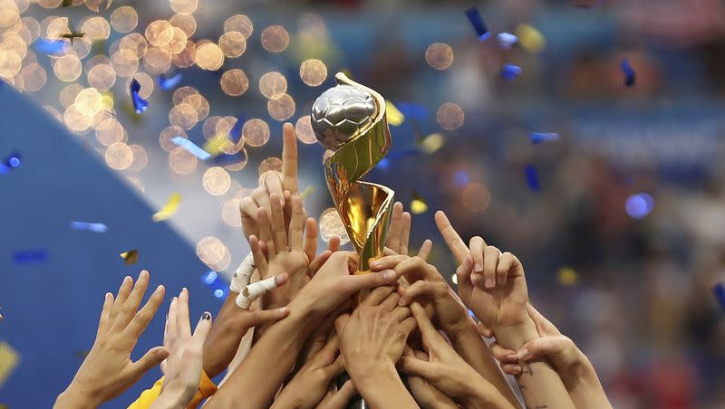 The United States players hold the trophy as they celebrate winning the Women’s World Cup final soccer match against The Netherlands at the Stade de Lyon in Decines, outside Lyon, France, on July 7, 2019. The 2023 Women’s World Cup will be spread across nine cities in Australia and New Zealand. 