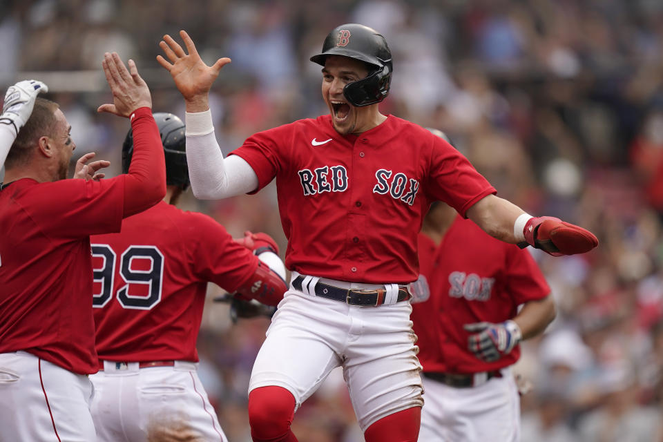 Boston Red Sox's Enrique Hernandez, center, celebrates with teammates after scoring on a sacrifice fly by Xander Bogaerts in the eighth inning of a baseball game against the New York Yankees, Sunday, July 25, 2021, in Boston. (AP Photo/Steven Senne)