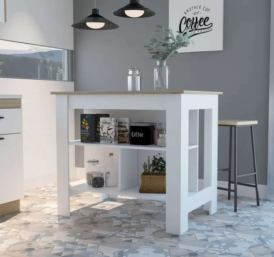 White kitchen island with shelving on the bottom, wooden table top, and bar stool