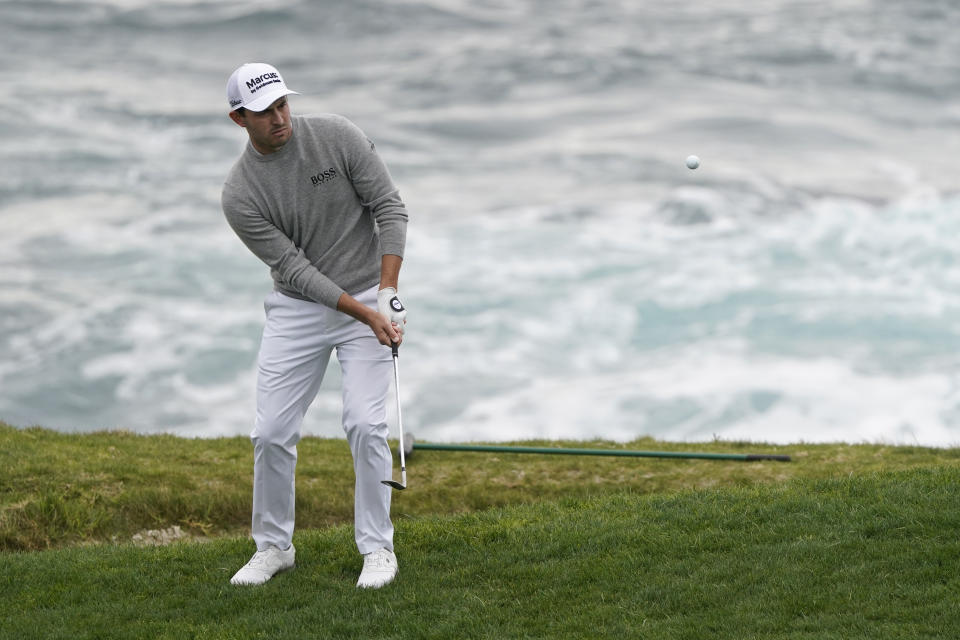 Patrick Cantlay hits the ball onto the seventh green of the Pebble Beach Golf Links during the final round of the AT&T Pebble Beach Pro-Am golf tournament Sunday, Feb. 14, 2021, in Pebble Beach, Calif. (AP Photo/Eric Risberg)