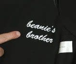 A close-up of Jonah's sweatshirt that reads, "Beanie's brother" in cursive