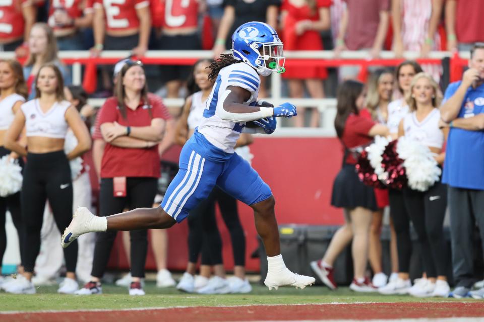 BYU Cougars running back Deion Smith (20) scores a touchdown in the first quarter against the Arkansas Razorbacks at Donald W. Reynolds Razorback Stadium.