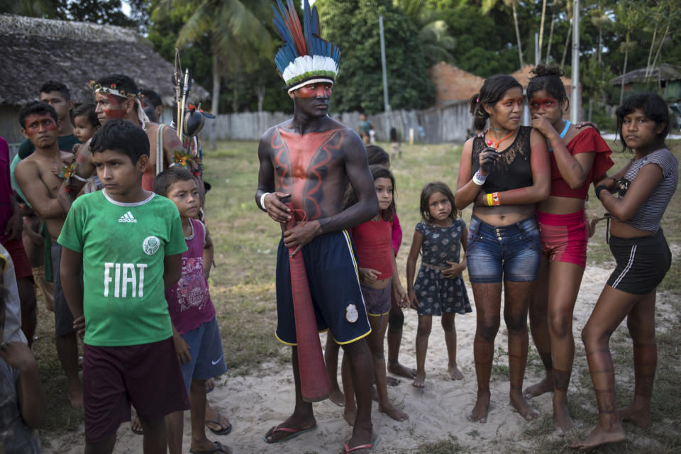 In this Sept. 3, 2019 photo, villagers gather during a meeting of Tembé tribes at the Tekohaw indigenous reserve, Para state, Brazil. About 600 members of the tribe live in Tekohaw. It’s located on the banks of the Gurupi River where many fish for piranhas and other fish that they later grill over wood fires. (AP Photo/Rodrigo Abd)