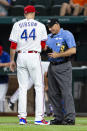 Home plate umpire Dan Iassogna, right, inspects the glove of Texas Rangers starting pitcher Kyle Gibson (44) after the second inning of a baseball game against the Oakland Athletics, Monday, June 21, 2021, in Arlington, Texas. (AP Photo/Sam Hodde)