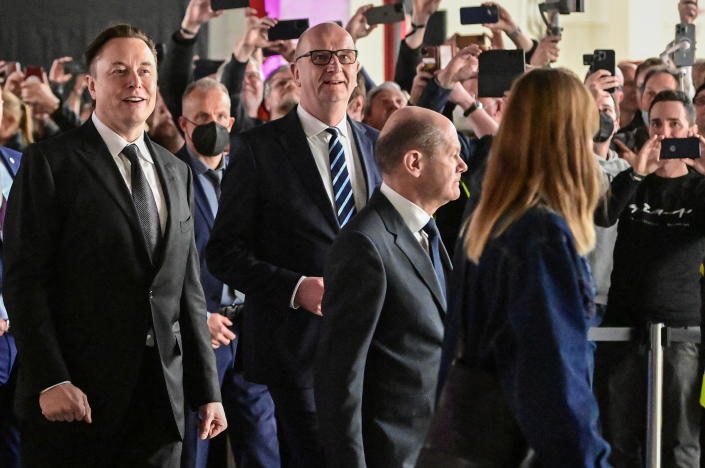 German Chancellor Olaf Scholz, Brandenburg Premier Dietmar Woidke and Elon Musk attend the opening ceremony of the new Tesla Gigafactory for electric cars in Gruenheide, Germany, March 22, 2022. Patrick Pleul/Pool via REUTERS