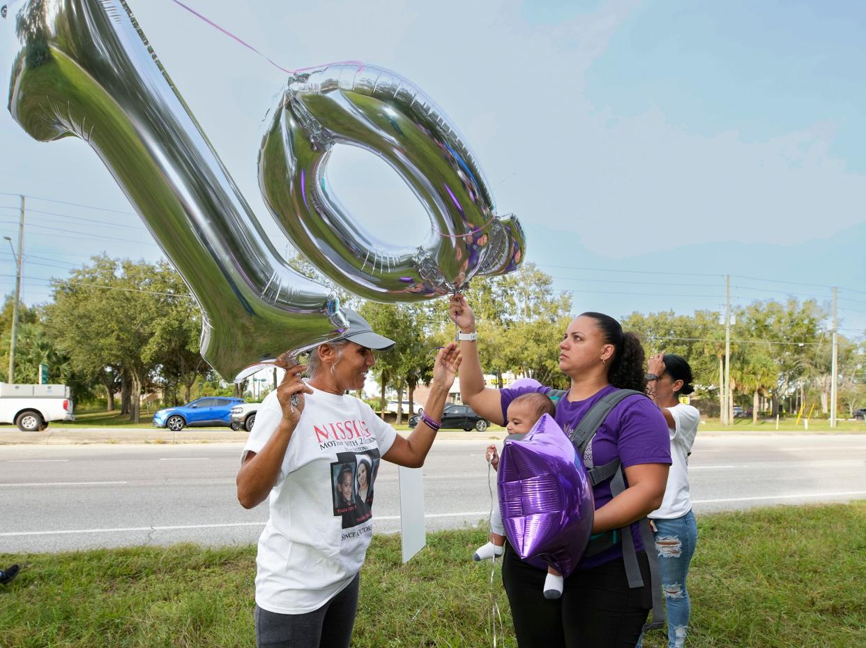 Felicita Nieves with her daughter, Emily Mejia, along with family and friends, prepare to release balloons on the 10th anniversary of the murder of Yessenia Suarez and her two children, Thalia Otto, 9, and Michael Elijah Otto, 8, in Deltona, Monday, Oct. 23, 2023.