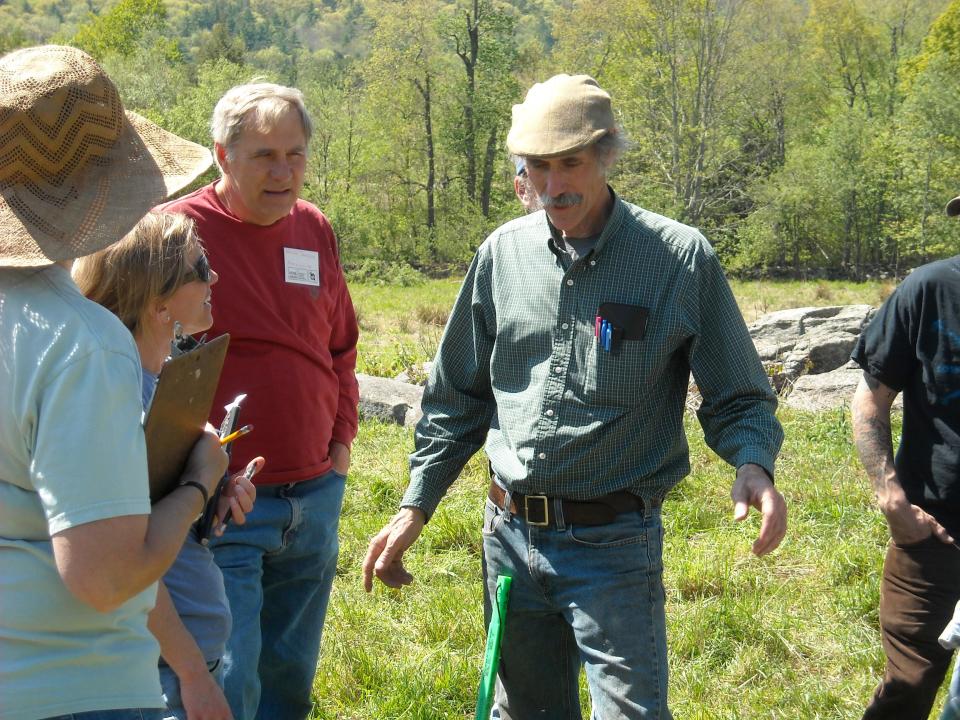 Grazier Ridge Shinn, middle, speaks to a group of visitors to his farm in Hardwick