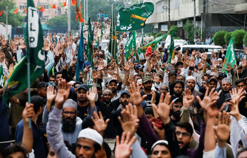 FILE PHOTO: People chant slogans against the satirical French weekly newspaper Charlie Hebdo, which reprinted a cartoon of the Prophet Mohammad, during a protest in Karachi