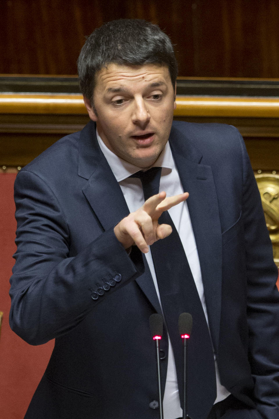 Premier Matteo Renzi delivers his speech prior to a confidence vote, at the Senate, in Rome, Monday, Feb. 24, 2014. Renzi is pitching for support in Parliament ahead of mandatory confidence votes on his brand-new coalition. Democratic Party leader Renzi told the Senate Monday he needs support for a "bold vision" that will get economically stagnate Italy dreaming again. Without giving details, Renzi said debt-laden Italy must heal its public finances not because Germany's leader, Angela Merkel or the European Central Bank chief want us "to get serous" but because "it's our children" who seek a future. (AP Photo/Andrew Medichini)