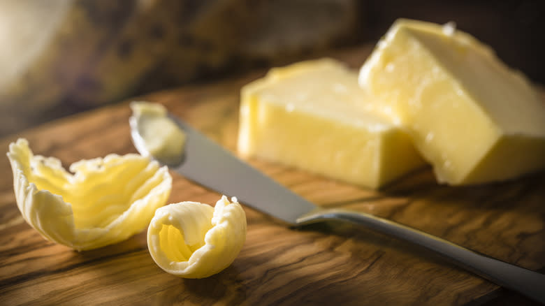 Butter on cutting board with knife