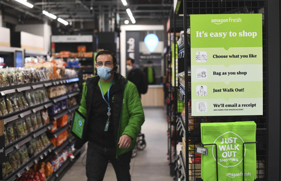 The Amazon Fresh grocery store opens in London, Thursday March 4, 2021, where a sign explains for shoppers to pick up items and walk out of the store, contactless, without the need for a till. Customers will scan a QR code on their way into the store, with cameras and technology identifying the items that shoppers take from the shelves and their account automatically paid. (Victoria Jones/PA via AP)