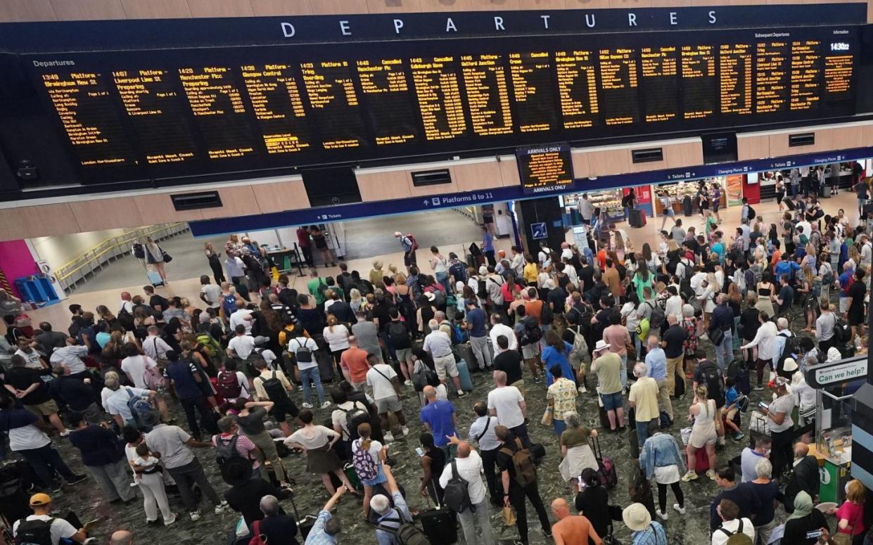 Passengers at Euston station in London following train cancellations last July - Yui Mok/PA